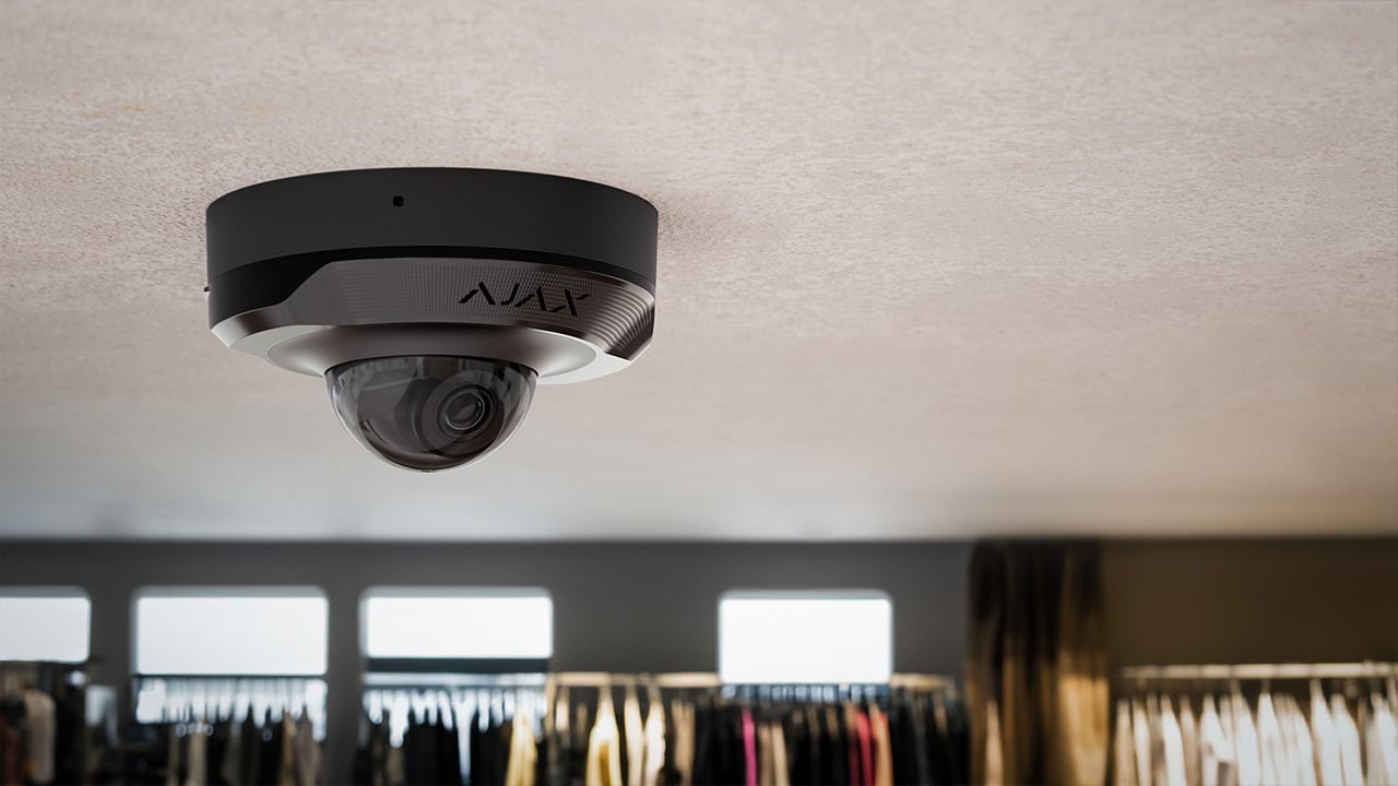 A dome-style CCTV camera mounted on the ceiling of a Brisbane clothing store