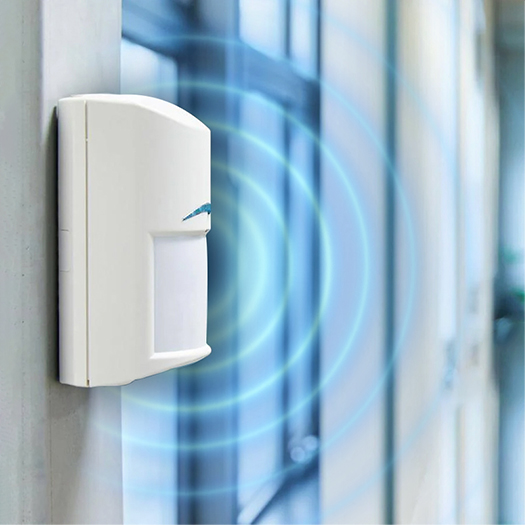 Bosch motion sensor mounted on a hallway wall in a Brisbane property, emitting detection waves.
