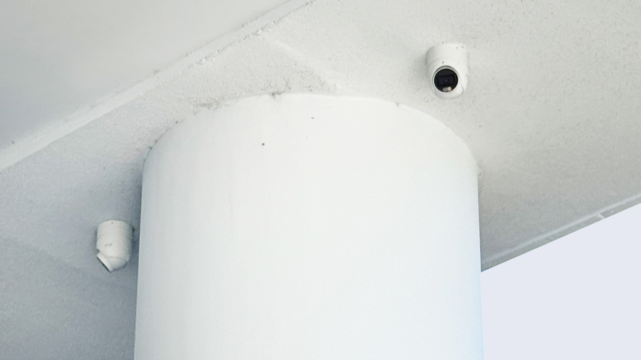 Two turret security cameras mounted on a ceiling column in a Brisbane commercial or residential setting