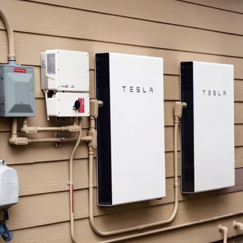 Filename: tesla_powerwall_thermal_camera_brisbane.jpg  
Alt: Tesla Powerwall monitored by a thermal camera in Brisbane  
Title: Thermal Camera Monitoring Tesla Powerwall in Brisbane  
Caption: A Tesla Powerwall system being monitored by a thermal camera in Brisbane, Australia  
Description: This image features a Tesla Powerwall energy storage system installed on the exterior of a building in Brisbane, Australia. A thermal camera is actively monitoring the Powerwall units to assess temperature variations, ensuring safe and efficient energy management. Tesla's innovative battery technology helps homeowners store solar energy and reduce dependence on the grid, with thermal monitoring enhancing system performance and safety.  